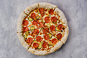 Pizza with pepperoni and cucumber slices