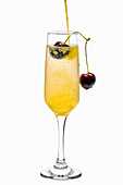 Mimosa cocktail with cherry and orange juice