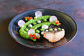 Grilled salmon with pea puree and radishes