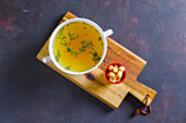 Chicken broth with herbs and croutons