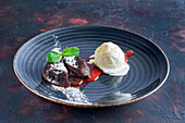 Chocolate fondant with vanilla ice cream and strawberry jam