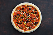 Pepperoni pizza with peppers, onions and olives