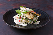 Fried fish fillet on rice with green beans and chard