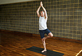 Mature Man Practicing Yoga, Tree pose