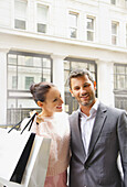 Smiling Couple on City Street with Shopping bags