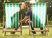 Couple Sitting on Deck Chairs Kissing, St. James's Park, London, England