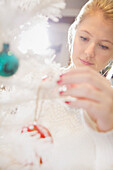 Close up of Young Woman Decorating Christmas Tree