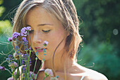 Young Woman Holding Flowers, Close-up view