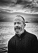 Contemplative mid-adult man with beard on sailboat