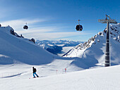 Austria,Tyrol,Sankt Anton am Arlberg ski resort ,a man alone skies on a ski slope
