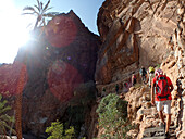 Sultanate of Oman,AS Sharqiyah region,Village of Bilad Sayt,a group of european tourists hikes through a gorge towards the village of Bilad Sayt