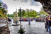 LOURDES - JUNE 15,2019: Pilgrimage of believers in front of the holy grotto of Lourdes