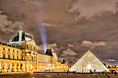 Paris. 1st district. Louvre Museum by night. The pyramid (architect: Ieoh Ming Pei). In the background the lighthouse of the Eiffel Tower.Mandatory credit of the architect architect: Ieoh Ming Pei
