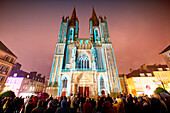 Normandy. Manche. Coutances. Cathedral. Mapping show on the cathedral during the end of year celebrations. Public in the foreground.