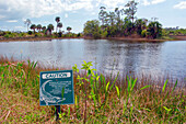 USA. Florida. Naples. Naples Botanical Garden. Danger sign for alligators.