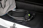 France. Seine et Marne. Electric car Renault Zoe. Close up on charging cable (type 2) in the car trunk.