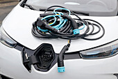 France. Seine et Marne. Electric car Renault Zoe. Close up on many charging cables (classical 220v,types 2 and 3),showing the complexity of cables choice.