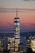 USA. New York City. Manhattan. Empire State Building. View from the top of the building at dusk and night. View of the One World Trade Center,lower town and financial district. The Hudson river is visible in the background.