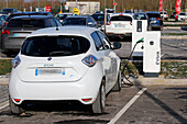 France. Seine et Marne. Coulommiers region. Commercial zone. Electric Renault Zoe car charging at a free Schneider Electric EVLINK terminal.