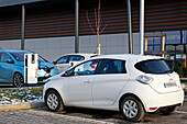 France. Seine et Marne. Coulommiers region. Commercial zone. Electric Renault Zoe cars charging at a free Schneider Electric EVLINK terminal.
