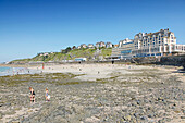 France. Normandy. Department of Manche. Granville during the summer. View from the coast and part of the beach. Le Normandy rehabilitation center. Tourists on the rocks.
