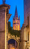 France,Gironde,Saint Emilion (UNESCO World Heritage Site),bell tower of the monolithic church seen from a medieval alley
