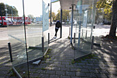 France,Nantes,44,Pirmil district,young man waiting for the bus at a stop.