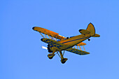 Biplane in a blue sky