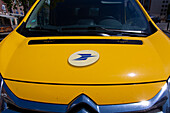 Yellow post vehicle with the logo on the hood