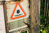 Sign: Attention ticks,at the entrance of a forest