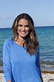 Woman in blue jumper on the beach