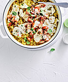 Coconut fish with turmeric rice in a pan