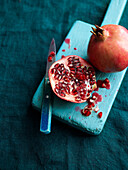Halved and whole pomegranate