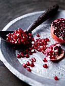 Pomegranate seeds on a silver plate