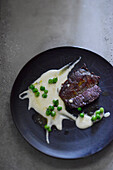 Veal flank with pea cream and peas