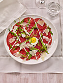 Carpaccio with truffle cream, parmesan, capers and rocket