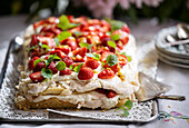 Meringue tart with strawberries and whipped cream