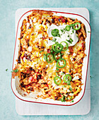 Mexican chicken and pasta casserole with cheese and jalapeños