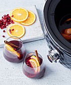 Mulled wine from the slow cooker with orange and pomegranate seeds