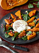 Warm salad with pumpkin, burrata and nuts