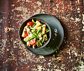 Pasta salad with vegetables and black pudding