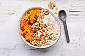 Carrot cake bowl with walnuts and apple pieces