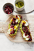 Slices of bread with avocado, egg and beetroot bites