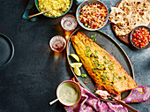 Tandoori salmon fillet with rice and side dishes