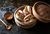 Steamed bao buns with crispy chicken and vegetables