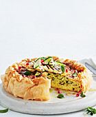 Vegetarian haloumi quiche with courgette and pomegranate seeds