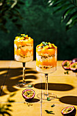 Mango and passion fruit layered dessert with mascarpone and quark cream