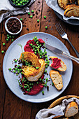 White cabbage steaks with beetroot hummus and peas