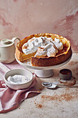 Apple juice tart with whipped cream and cinnamon
