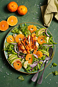 Rocket salad with cucumber, avocado, clementines, onions and chicken